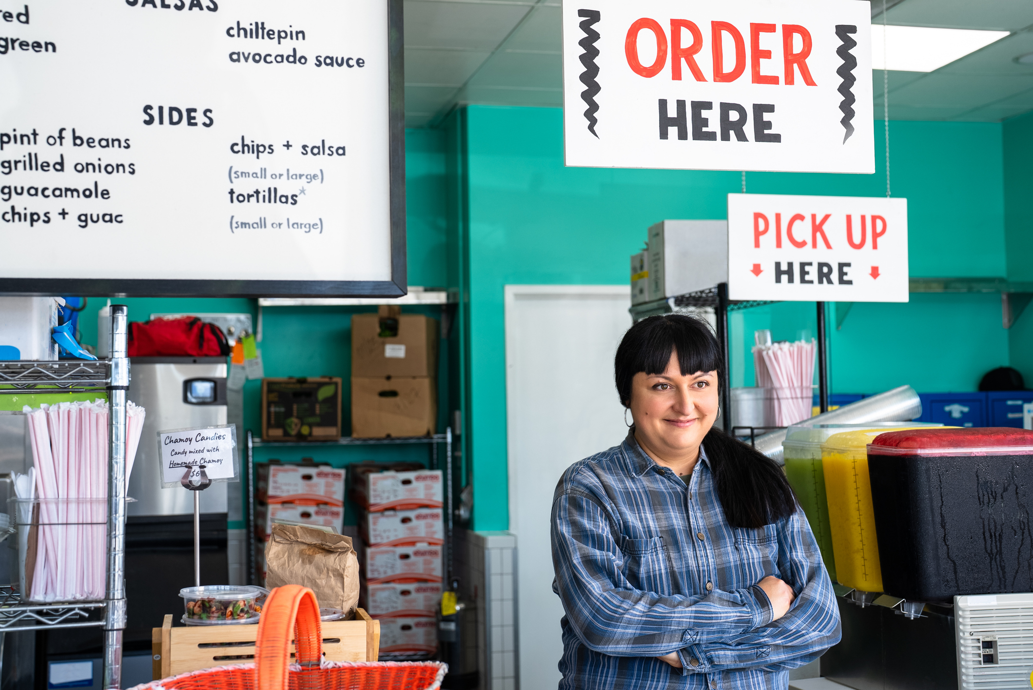Proud Restaurant Owner Standing under Order Here Sign
